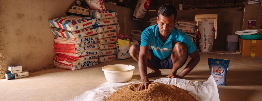 An Indian farmer with shrimp feed