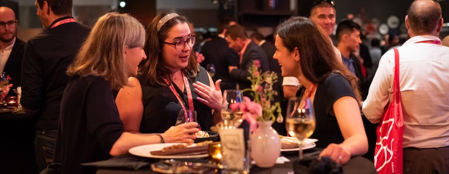 Women talking at a conference dinner