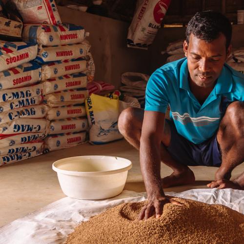 An Indian farmer with shrimp feed